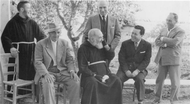 Padre Pio with people in the garden