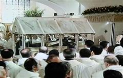 The friars passing the coffin