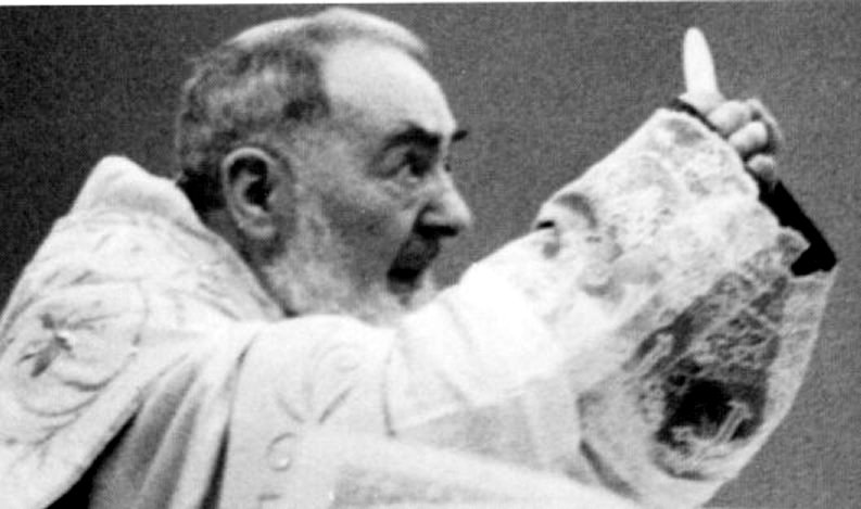 Padre Pio holding the host